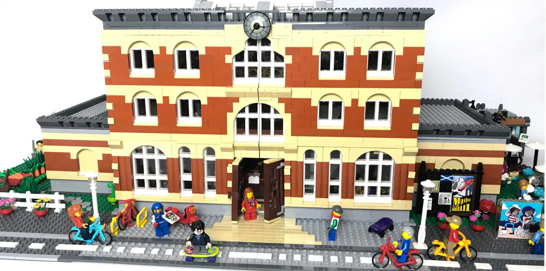 LEGO® Summerhall by Tammy Watchorn: the red-and-cream building with minifigures cycling and skateboarding outside