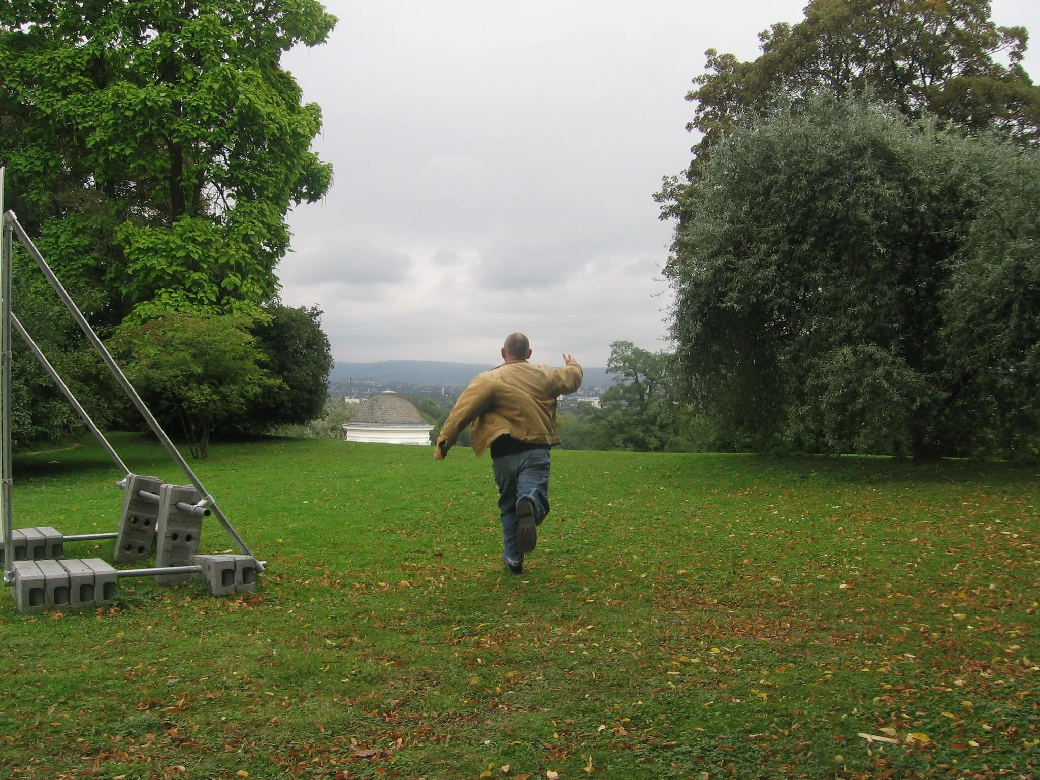 Photo of a man running away from his camera